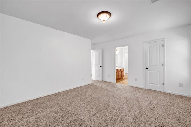 7601 Watson Cir, Locust Grove, GA 30248 - unfurnished bedroom with light carpet, baseboards, and ensuite bathroom