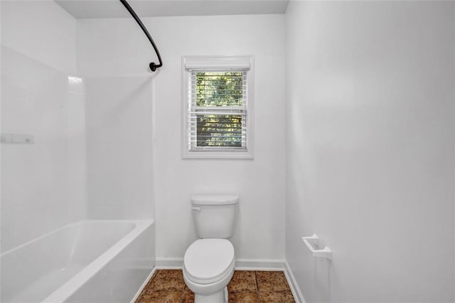 7601 Watson Cir, Locust Grove, GA 30248 - bathroom with toilet, baseboards, and bathtub / shower combination