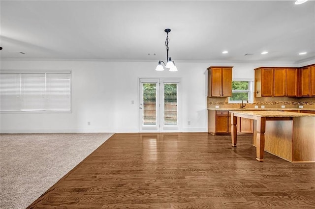 7601 Watson Cir, Locust Grove, GA 30248 - kitchen with recessed lighting, open floor plan, brown cabinets, tasteful backsplash, and a kitchen bar