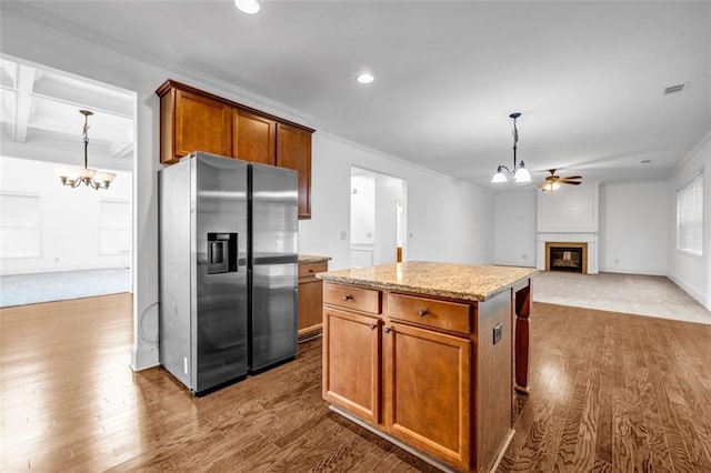 7601 Watson Cir, Locust Grove, GA 30248 - kitchen featuring a chandelier, stainless steel refrigerator with ice dispenser, dark wood-style floors, a glass covered fireplace, and recessed lighting