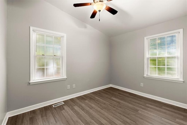 empty room with lofted ceiling, ceiling fan, and dark hardwood / wood-style flooring