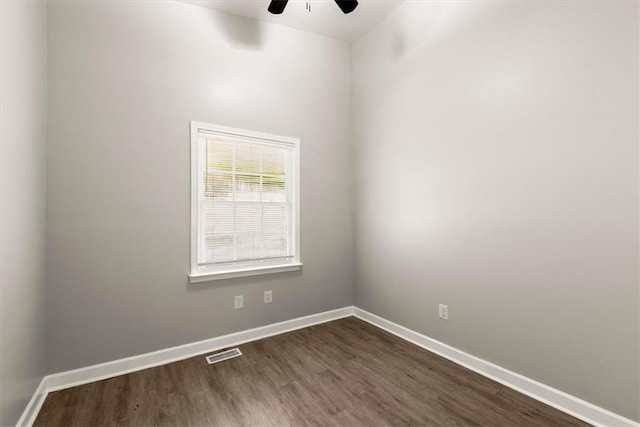 unfurnished room with ceiling fan and dark hardwood / wood-style flooring