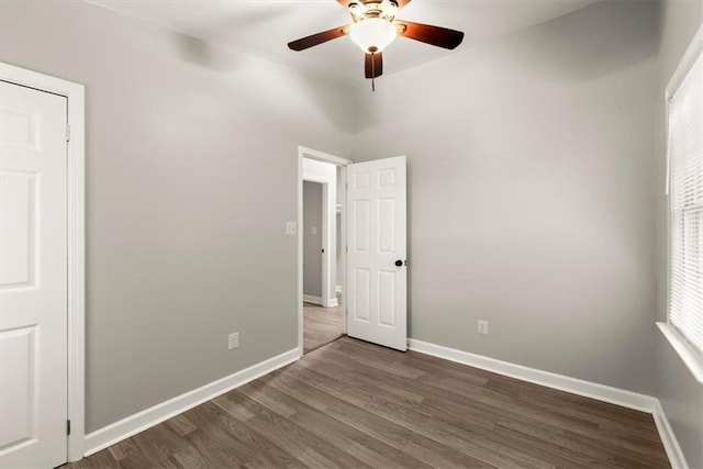 unfurnished bedroom featuring dark hardwood / wood-style floors and ceiling fan