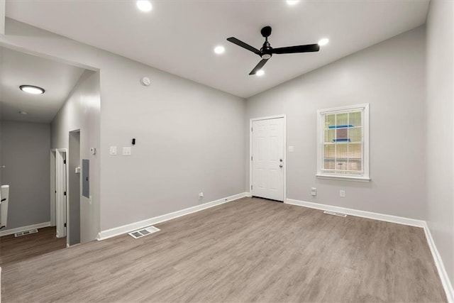 spare room featuring high vaulted ceiling, light wood-type flooring, and ceiling fan