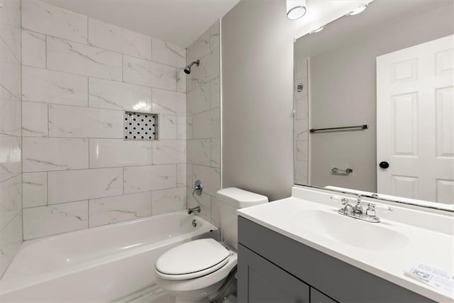 full bathroom featuring vanity, toilet, and tiled shower / bath combo