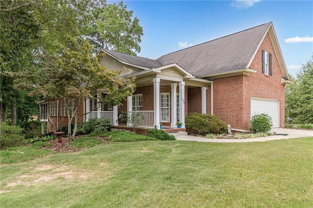 view of front of home with a garage, a front yard, brick siding, and a porch