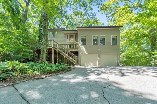 view of front of house with a garage and a wooden deck