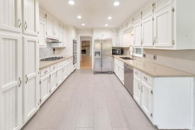 kitchen featuring white cabinetry, sink, and appliances with stainless steel finishes