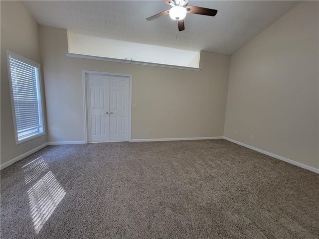 983 Noble Oak Ct, Lawrenceville, GA 30046 - carpeted empty room featuring ceiling fan, plenty of natural light, vaulted ceiling, and baseboards