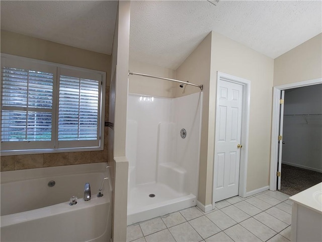 983 Noble Oak Ct, Lawrenceville, GA 30046 - full bath featuring tile patterned floors, a garden tub, a textured ceiling, baseboards, and a shower