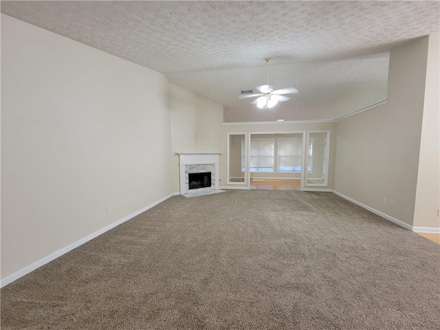983 Noble Oak Ct, Lawrenceville, GA 30046 - unfurnished living room featuring ceiling fan, baseboards, carpet floors, vaulted ceiling, and a textured ceiling
