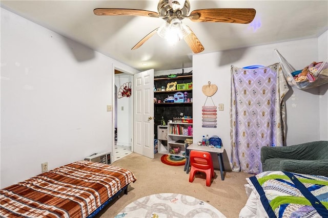 bedroom with ceiling fan, visible vents, and carpet flooring