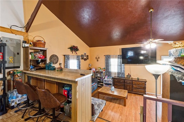 kitchen with a ceiling fan, lofted ceiling, and parquet floors