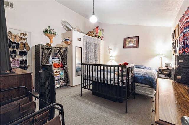 bedroom featuring carpet, visible vents, and vaulted ceiling