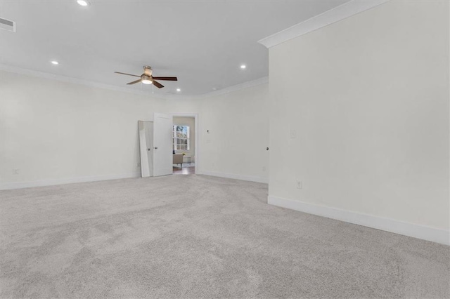 spare room featuring a ceiling fan, baseboards, recessed lighting, ornamental molding, and light carpet