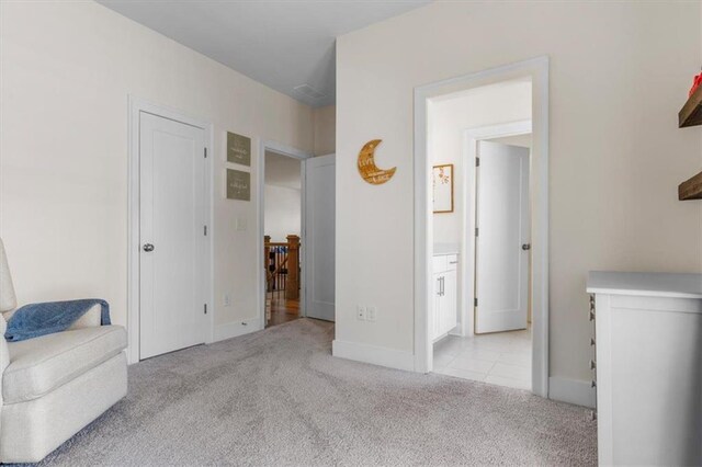 living area featuring baseboards and carpet