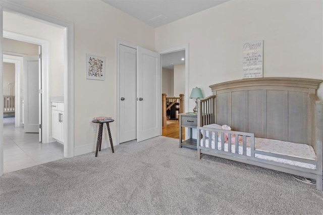 bedroom with tile patterned floors, baseboards, and carpet floors