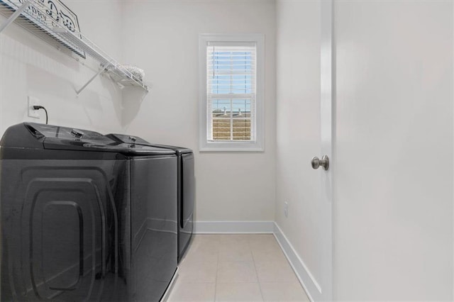 washroom with laundry area, light tile patterned floors, baseboards, and independent washer and dryer