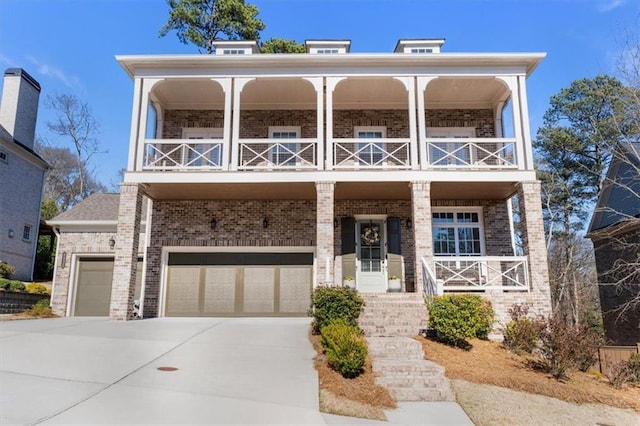 view of front facade with brick siding, a porch, concrete driveway, and a balcony