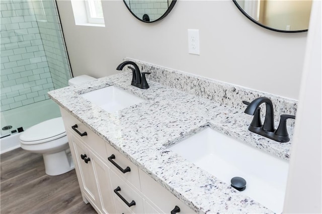 121 Hunters Ln, Powder Springs, GA 30127 - bathroom with a sink, toilet, a shower stall, and wood finished floors