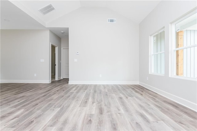 121 Hunters Ln, Powder Springs, GA 30127 - empty room featuring light wood finished floors, visible vents, baseboards, and lofted ceiling