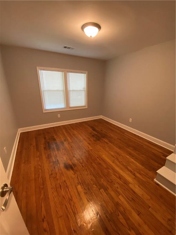 2319 Beecher Rd SW, Atlanta, GA 30311 - spare room featuring dark wood-style floors and baseboards