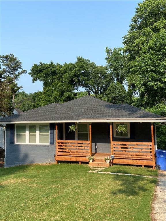 2319 Beecher Rd SW, Atlanta, GA 30311 - view of front of property featuring brick siding, a front yard, a porch, and roof with shingles