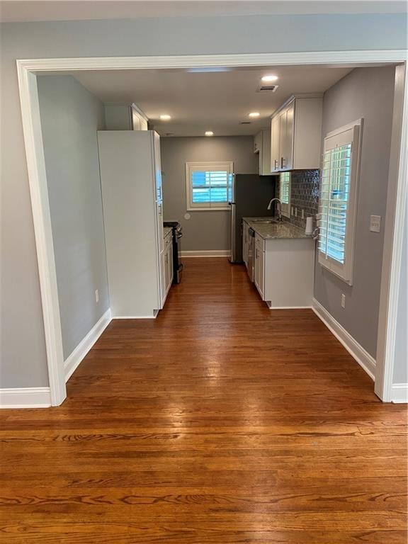 2319 Beecher Rd SW, Atlanta, GA 30311 - kitchen with dark wood-style flooring, baseboards, a sink, decorative backsplash, and stainless steel appliances