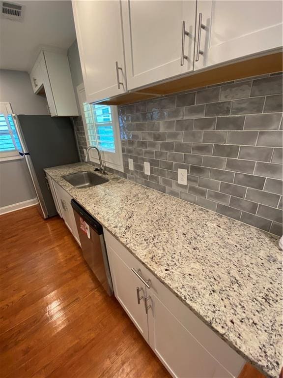 2319 Beecher Rd SW, Atlanta, GA 30311 - kitchen with a sink, wood finished floors, dishwasher, tasteful backsplash, and light stone countertops