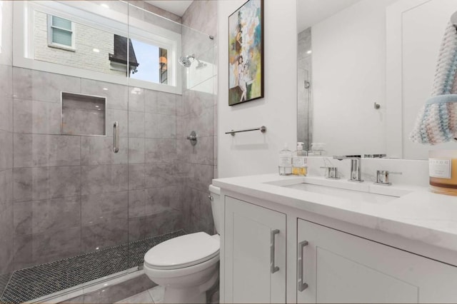 full bathroom with a stall shower, toilet, and vanity