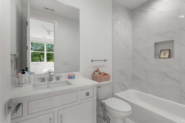 bathroom with toilet, vanity, and washtub / shower combination