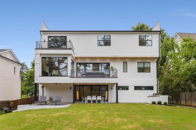back of house featuring a balcony and a patio