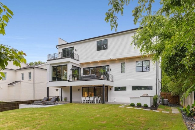 rear view of property featuring a balcony, cooling unit, and a patio area