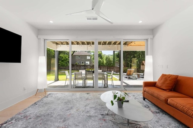 living area featuring baseboards, recessed lighting, and wood finished floors