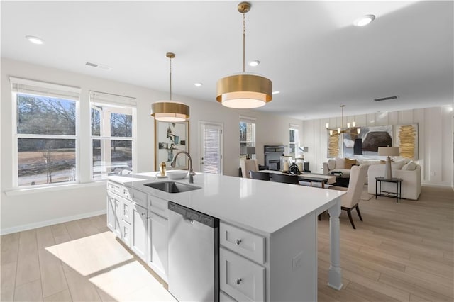 209 Chiswick Loop, Stockbridge, GA 30281 - kitchen featuring stainless steel dishwasher, an island with sink, light wood-type flooring, pendant lighting, and recessed lighting