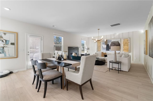 209 Chiswick Loop, Stockbridge, GA 30281 - dining area with a chandelier and light wood-style flooring