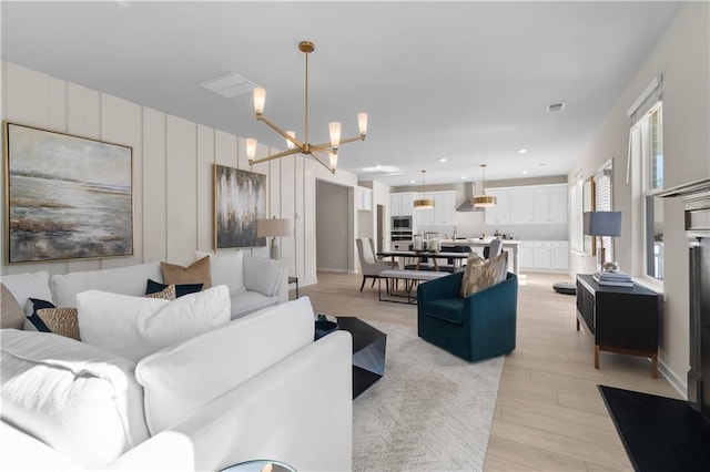 209 Chiswick Loop, Stockbridge, GA 30281 - living room featuring light wood-style flooring and a chandelier