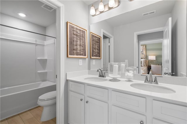 209 Chiswick Loop, Stockbridge, GA 30281 - ensuite bathroom with double vanity, bathtub / shower combination, and wood finished floors