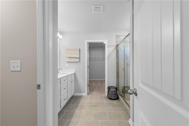 209 Chiswick Loop, Stockbridge, GA 30281 - full bath featuring a shower stall, vanity, a walk in closet, and tile patterned floors
