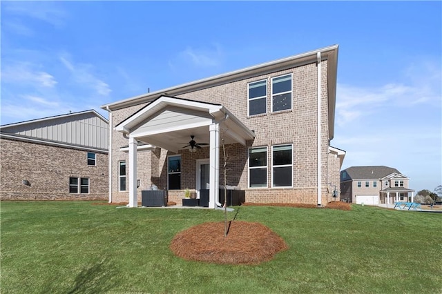 209 Chiswick Loop, Stockbridge, GA 30281 - back of house with a ceiling fan, brick siding, and a yard