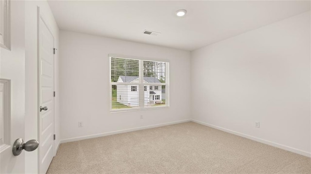 unfurnished bedroom featuring light colored carpet, visible vents, and baseboards