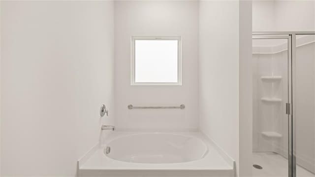 full bath featuring a garden tub and a shower stall