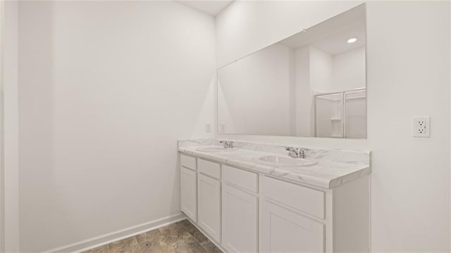 bathroom featuring vanity and a shower with shower door