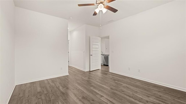 spare room featuring ceiling fan and dark hardwood / wood-style floors