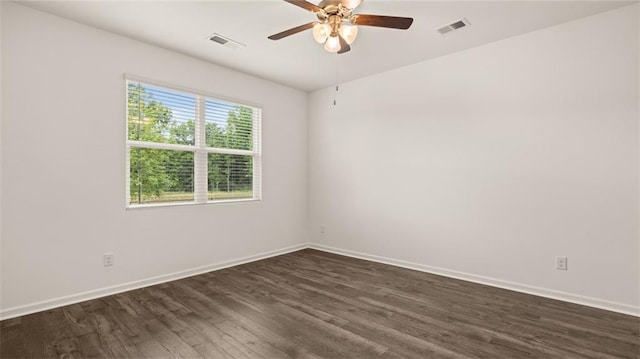 empty room with visible vents, dark wood finished floors, baseboards, and ceiling fan