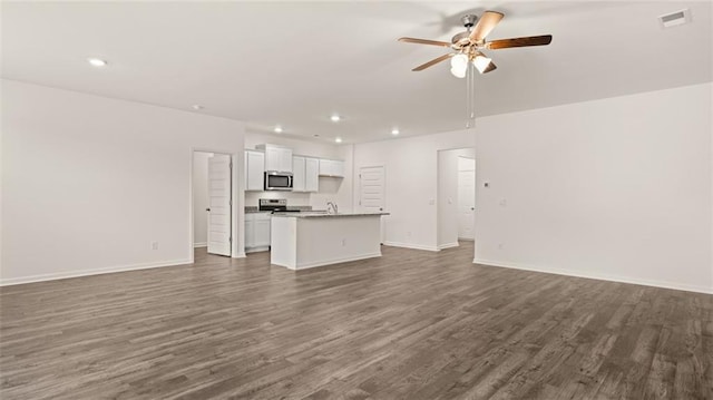 unfurnished living room featuring ceiling fan, sink, and dark wood-type flooring