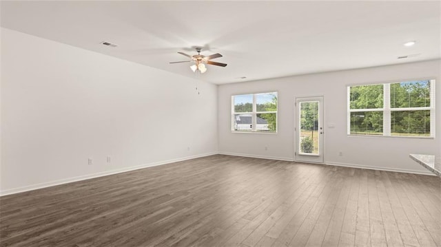 empty room featuring ceiling fan and dark hardwood / wood-style flooring