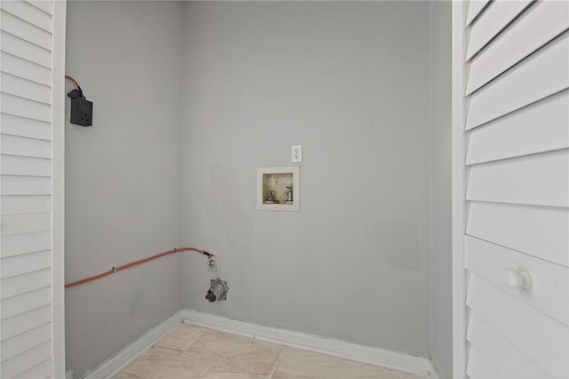 laundry area featuring baseboards and washer hookup