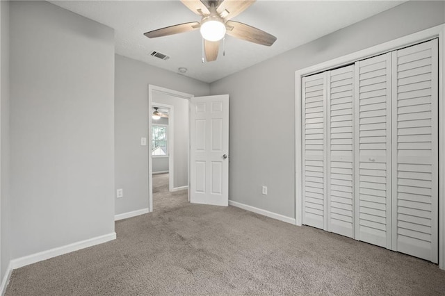 unfurnished bedroom featuring a closet, visible vents, baseboards, and carpet