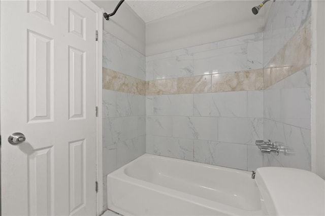 bathroom featuring toilet and washtub / shower combination